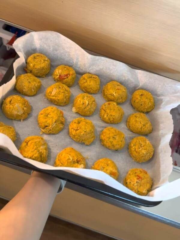 Neatly arranged homemade dog food scoops on a tray ready for flash freezing in the freezer
