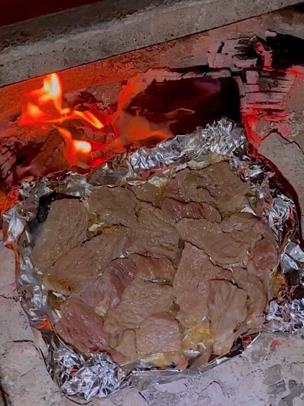 San Clemente Pet Friendly Camping: Our Foil Grill Fail Raw meat cooking on a DIY foil grill over an open campfire