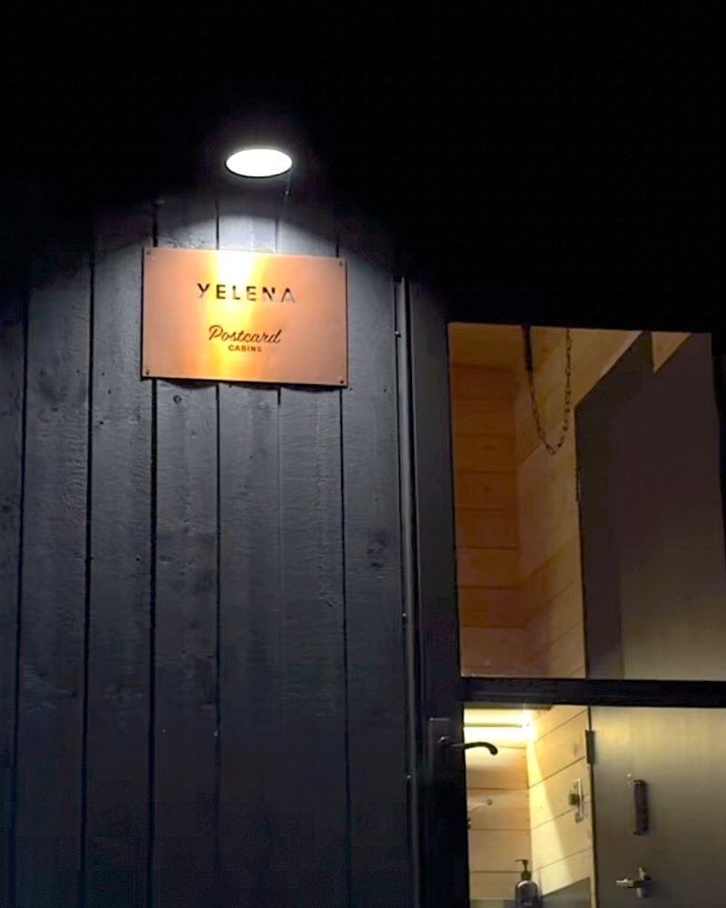 Cozy Getaway cabin Yelena sign lit up at night