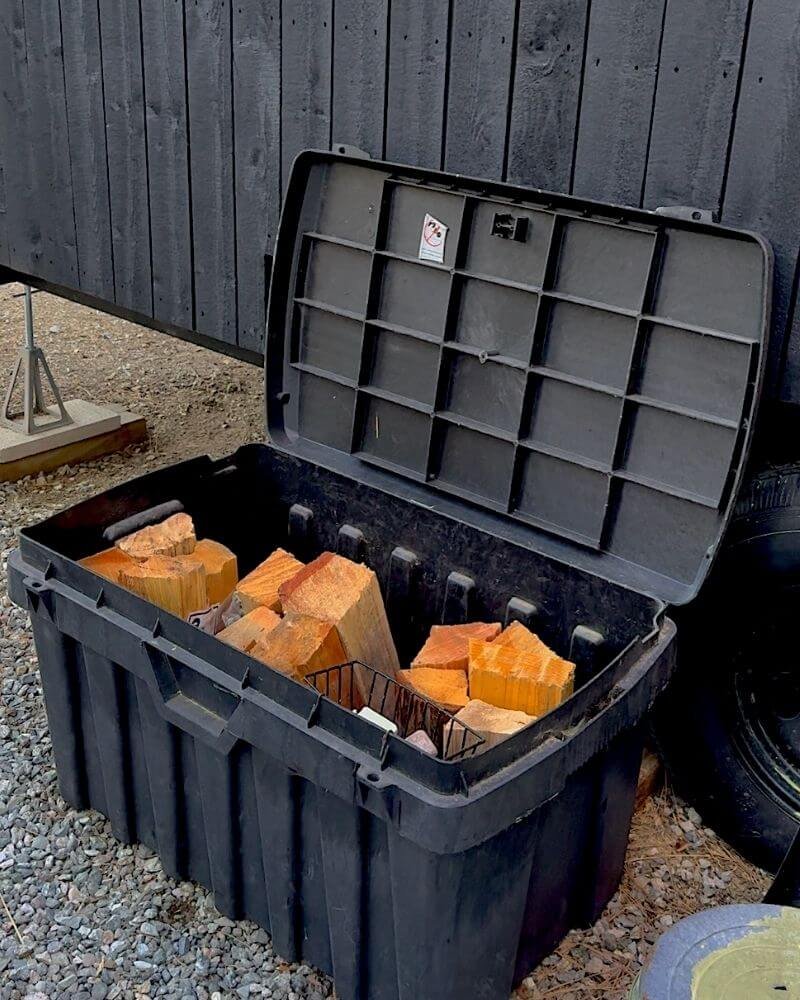 Outdoor firewood storage bin with pre cut logs provided at Getaway House