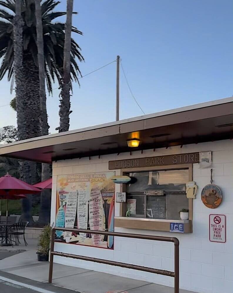 Hobson Park Store and burger grill counter under tall palm trees