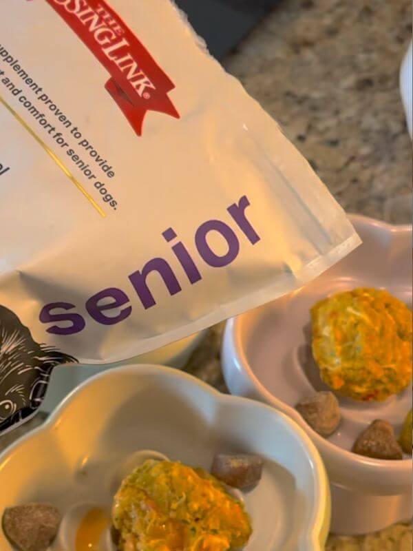 The Missing Link Senior supplement powder bag placed near a senior dog meal bowl for joint and calcium support