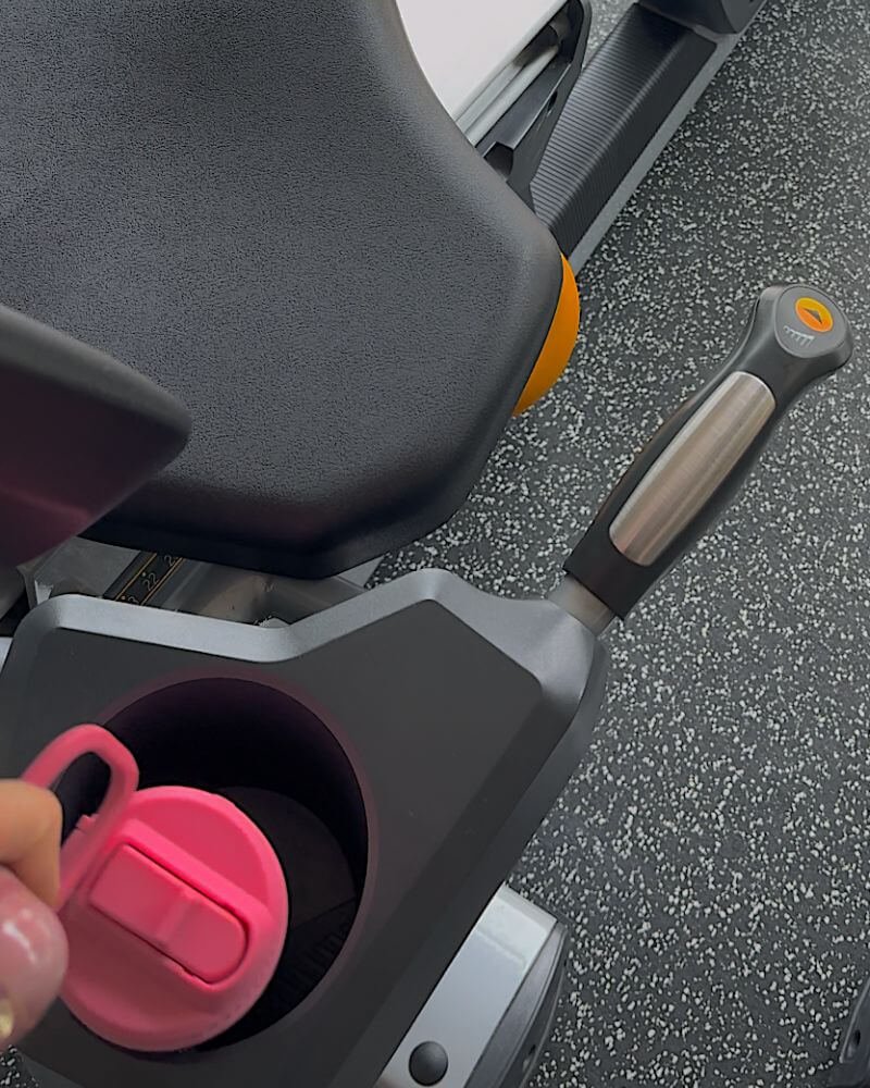 Stationary bike setup with a pink water bottle for indoor cycling