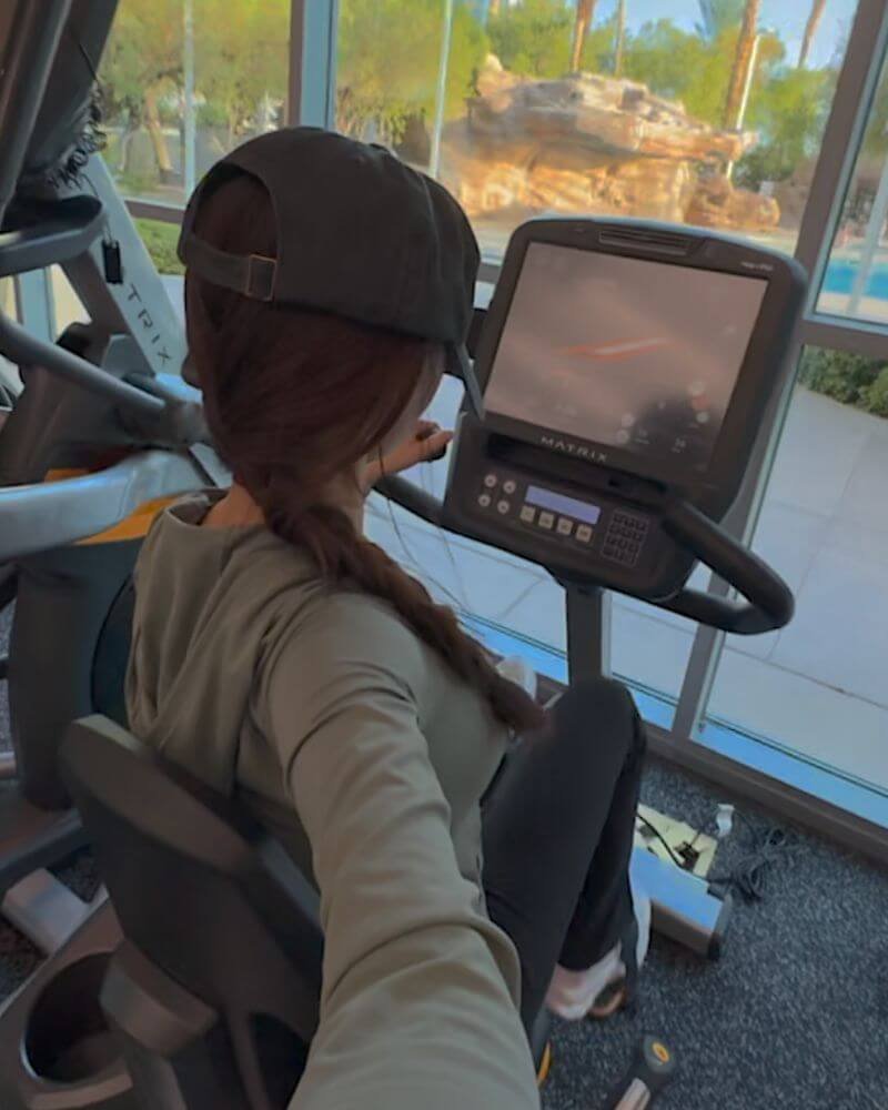 Enjoying a peaceful morning Zone 2 stationary bike session overlooking palm trees