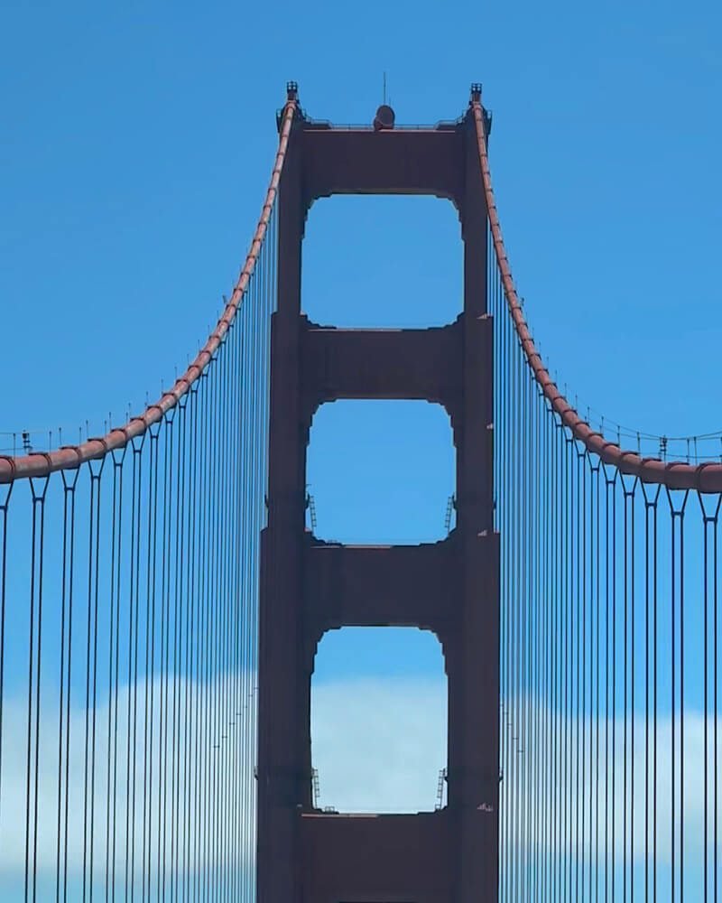 Dog Friendly San Francisco: Two Days With Three Small Dogs Golden Gate Bridge tower from below while driving south across the bridge into San Francisco