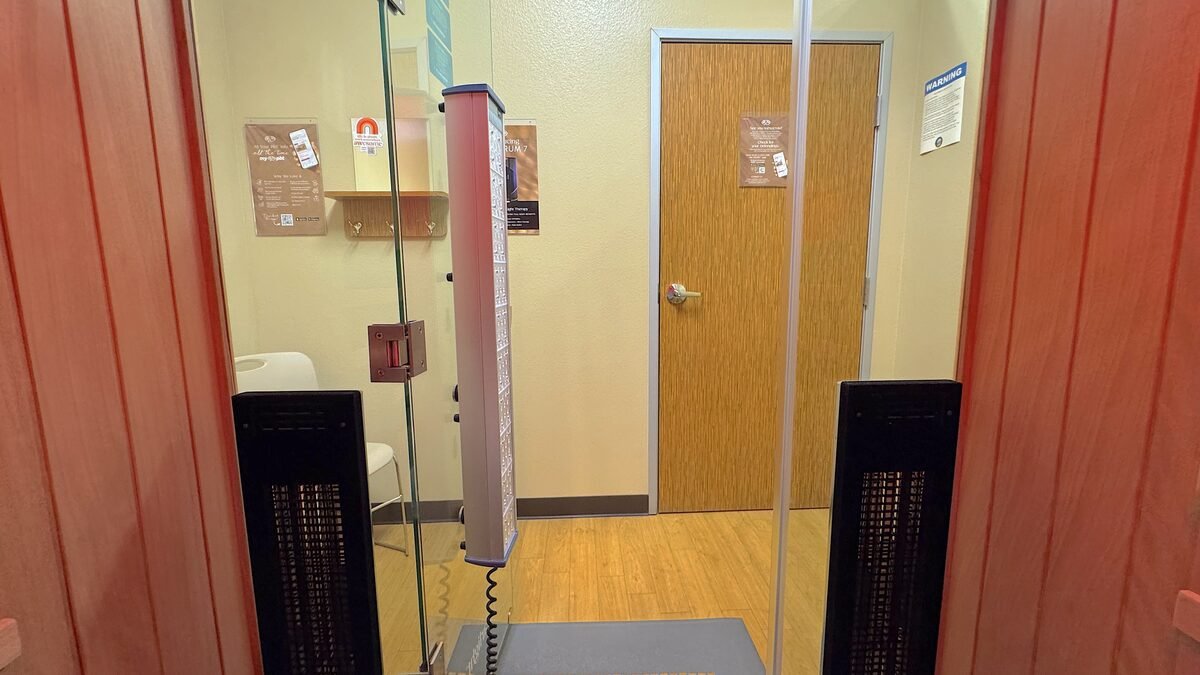 The booth door standing open at the end of a session with the hallway behind it