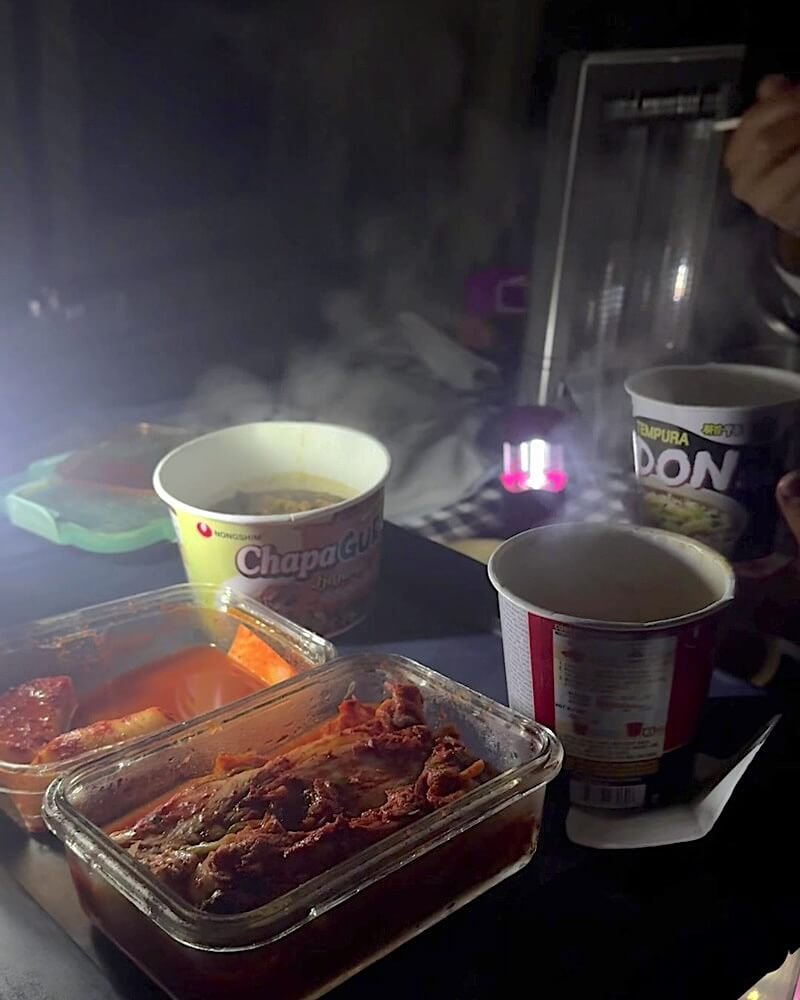 Tent Camping With Dogs: Three Nights With No Power Cup udon and reheated side dishes on a camp table at night