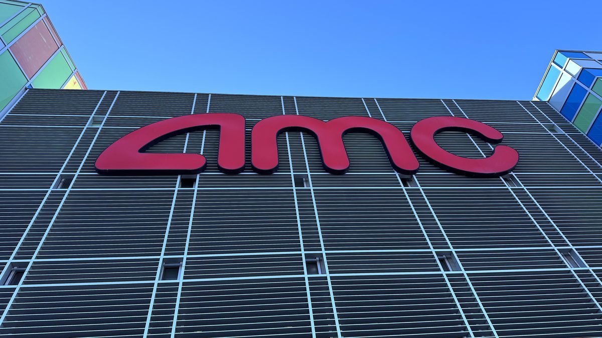 Is Beware Boiuna Worth Watching? 7/10 and Jump Scare Times (No Spoilers) Is Beware Boiuna worth watching: the red AMC sign on the theater building under a clear blue sky