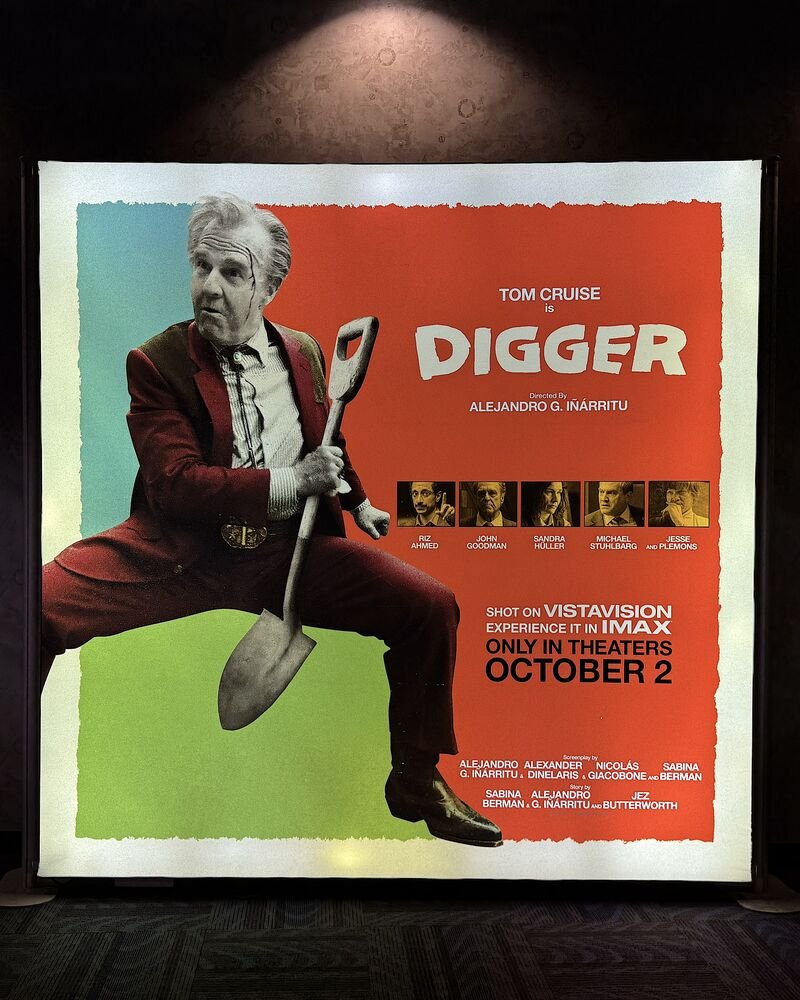 Is Digger 2026 worth watching: the Digger poster lightbox with Tom Cruise holding a shovel in an AMC hallway