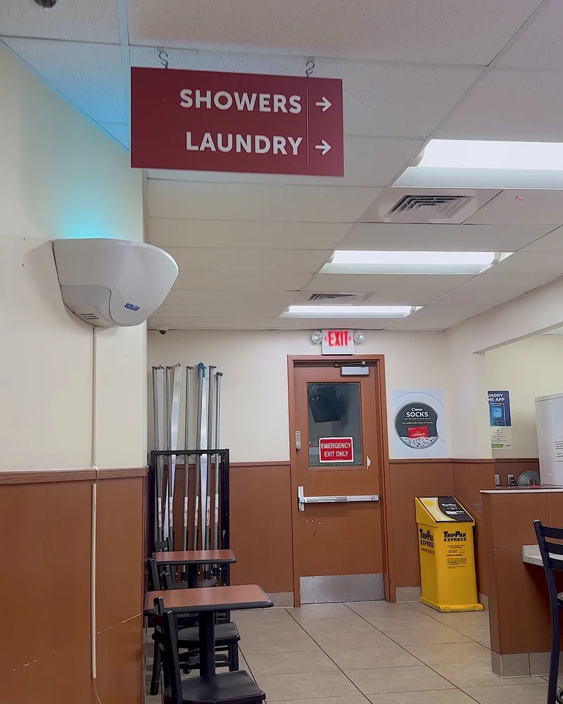 Truck Stop Showers: What Our First Pilot Shower Was Really Like (and What It Cost) Truck stop showers and laundry sign hanging inside a Pilot travel center