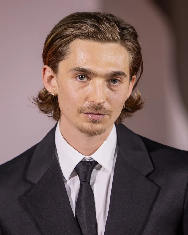 Austin Abrams, who plays medical courier Bryan in Resident Evil 2026, in a dark suit at the Venice International Film Festival