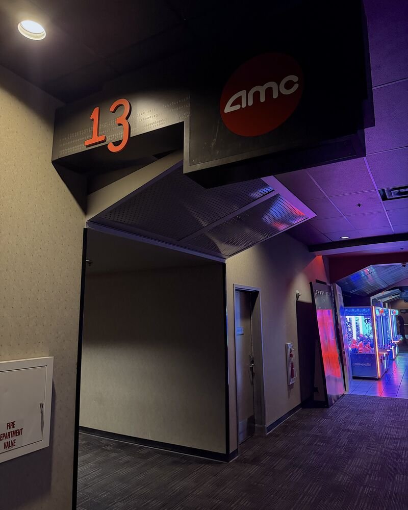 I Almost Skipped The Nightmare Before Christmas 3D. One Scene Changed My Mind AMC theater hallway with an auditorium number sign and the AMC logo above the entrance