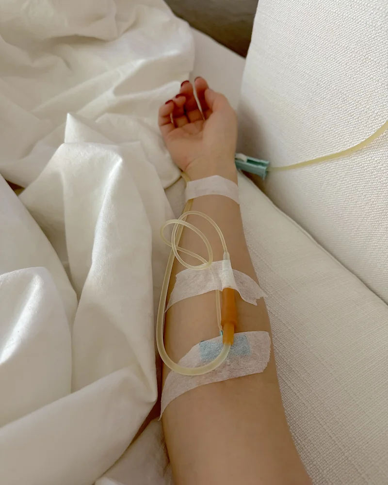 NAD IV Therapy: What My First 1,000 mg Drip Was Like (And the Week After) An IV line taped along my forearm with yellow-tinted tubing while I rest on white sheets