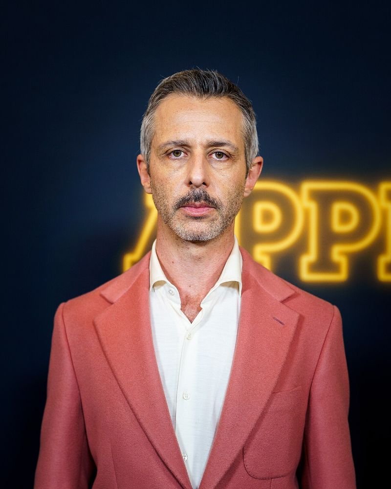 Is The Social Reckoning Worth Seeing? My 7.5/10 Review (No Spoilers) Jeremy Strong, who plays Mark Zuckerberg in The Social Reckoning, in a pink suit at a New York movie event