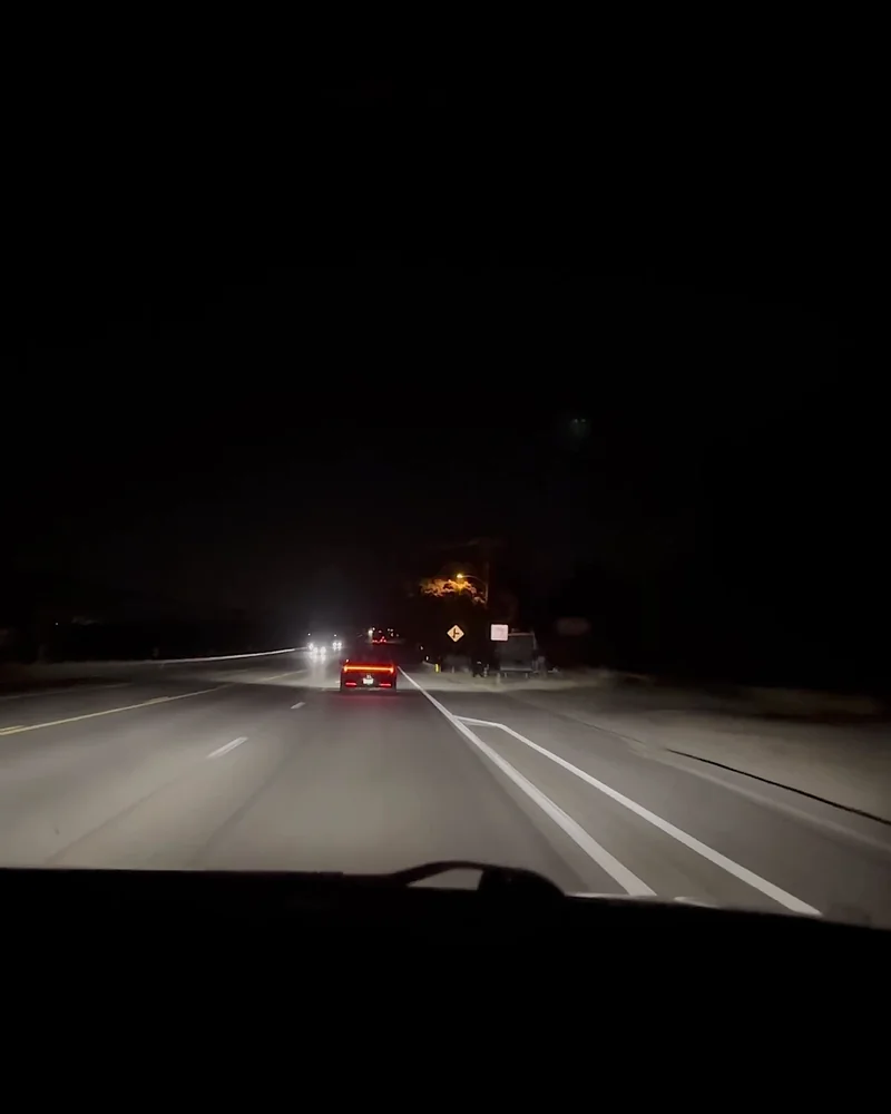 Truck Stop Showers: What Our First Pilot Shower Was Really Like (and What It Cost) Dark freeway at night seen through a car windshield