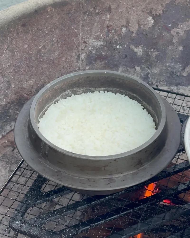 Camping Food List: What We Actually Ate in 3 Nights (Korean Dinners, Drinks, and the Dogs' Food) Sotbap, white rice cooked in a Korean sot pot on a campfire grate