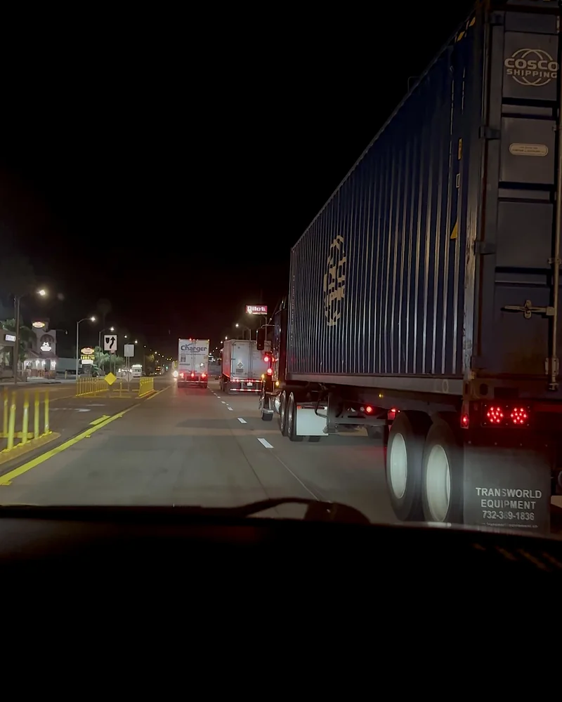 Truck Stop Showers: What Our First Pilot Shower Was Really Like (and What It Cost) Semi trucks lined up on a lit road near a truck stop at night
