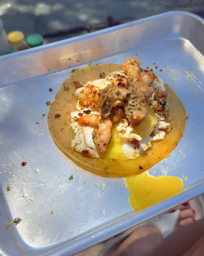 Easy Camping Breakfast: 4 Campfire Griddle Meals We Made (Nothing Prepped at Home) Shrimp and egg breakfast taco with chili flakes on a metal camp tray