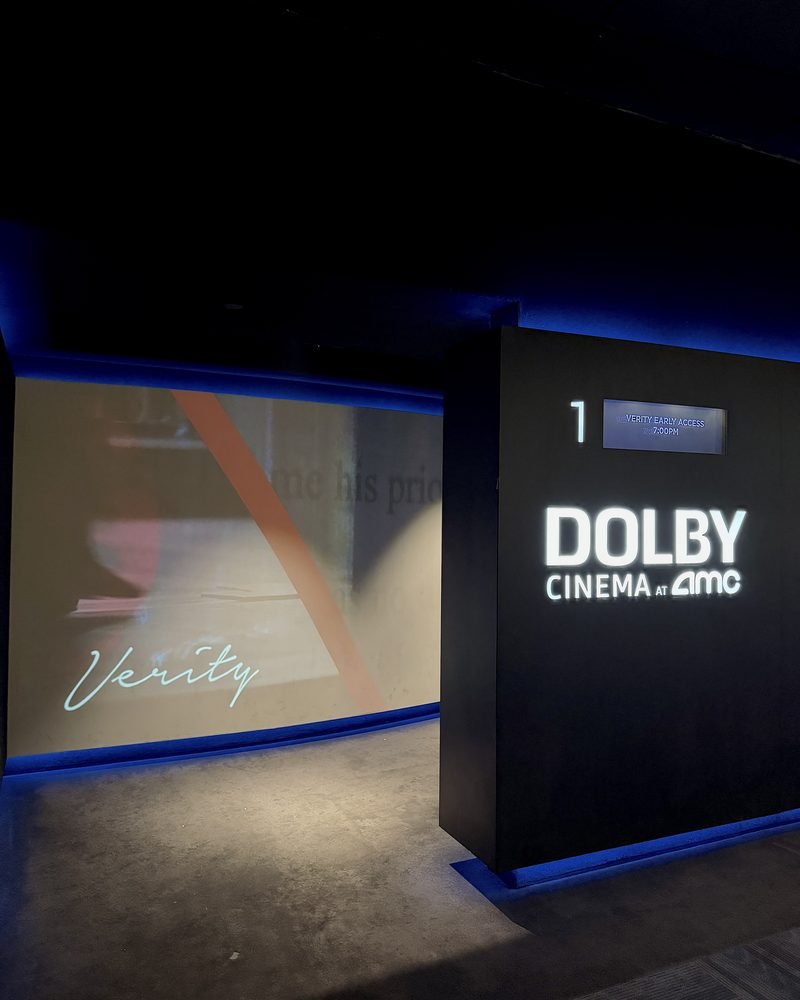 Side view of the Dolby Cinema auditorium entrance with the Verity title on the wall