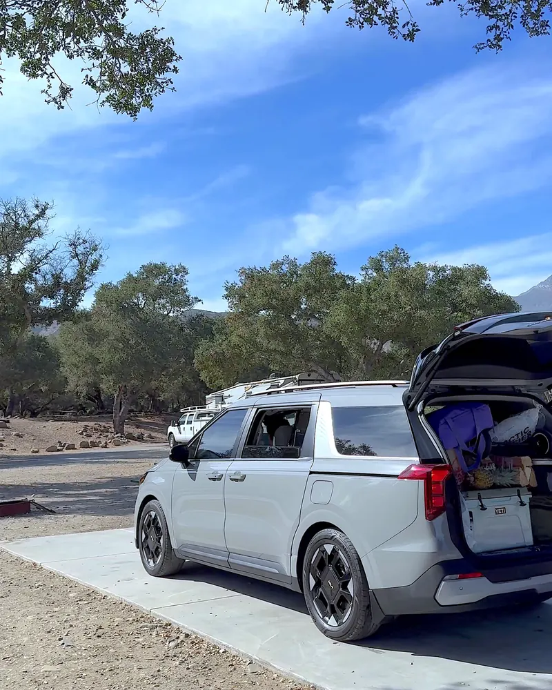 Steckel Park Camping With 3 Dogs: Our Honest Review of This Oak-Shaded Campground Silver minivan parked on a concrete campsite pad with the trunk open under oaks
