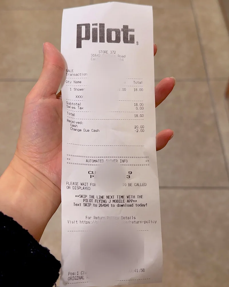 Truck Stop Showers: What Our First Pilot Shower Was Really Like (and What It Cost) Pilot shower receipt showing one shower for 18 dollars with personal details blurred