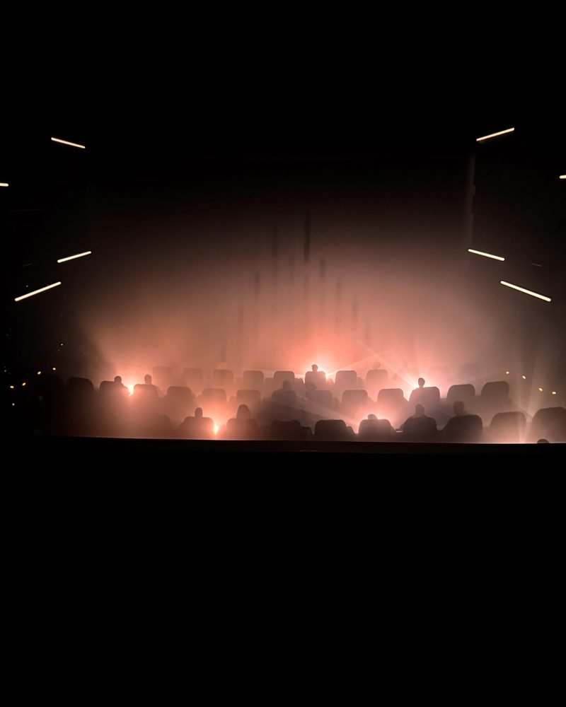 Dark Dolby Cinema auditorium with rows of seats before the movie started