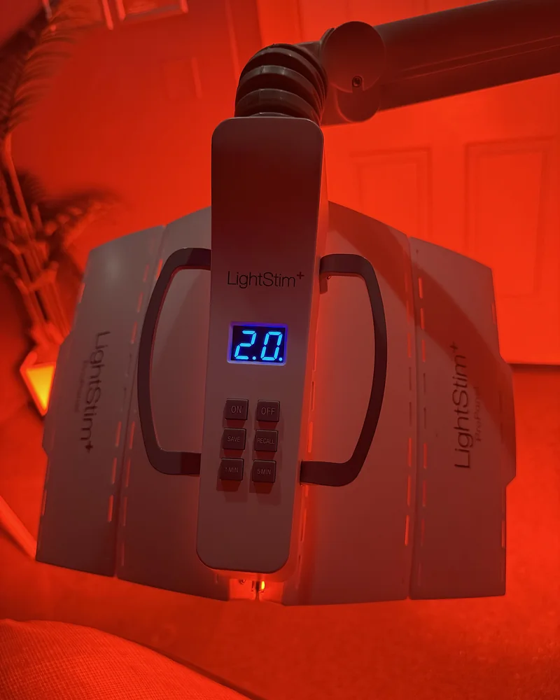 Tanning Salon Red Light Therapy: My Honest Routine After 10+ Face Sessions LightStim face panel glowing red with the display showing 20