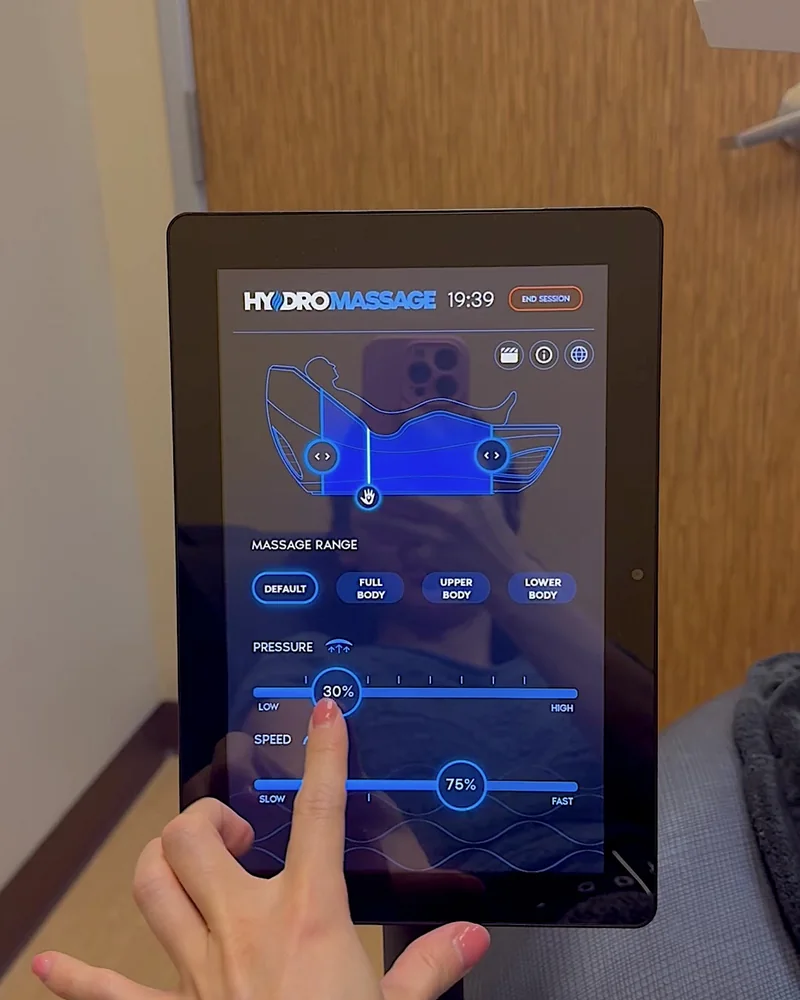 Hydromassage Bed: My Honest Review After 10+ Sessions (and the Exact Settings I Use) Finger tapping the pressure slider on a hydromassage touchscreen
