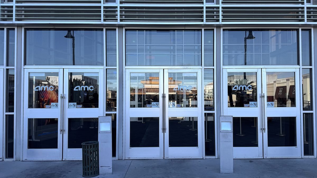 Is Beware Boiuna Worth Watching? 7/10 and Jump Scare Times (No Spoilers) Glass entrance doors with AMC logos at the movie theater