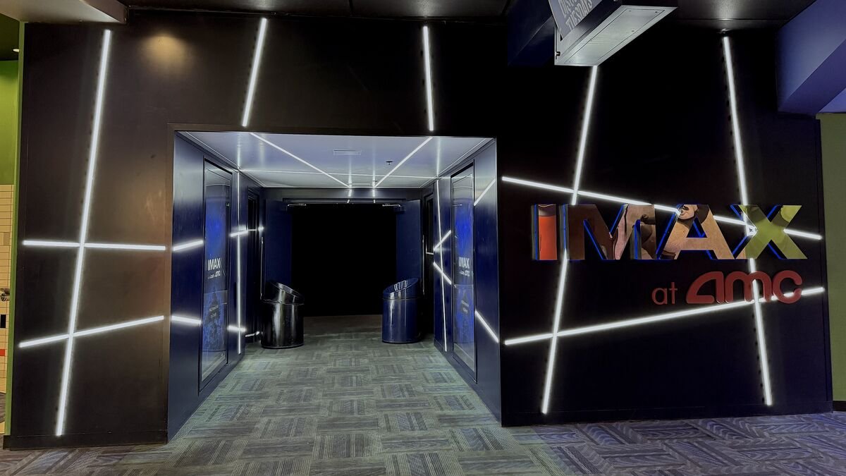 IMAX at AMC entrance hallway with glowing white light lines on dark walls