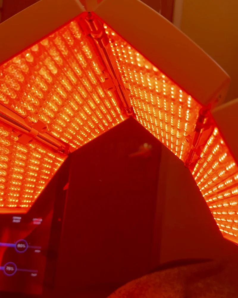 Tanning Salon Red Light Therapy: My Honest Routine After 10+ Face Sessions View looking up at a red LED panel from the massage bed