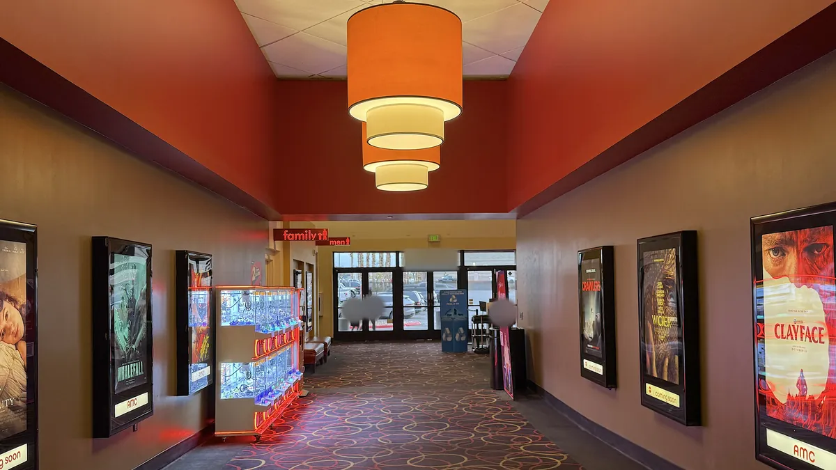 Is The Social Reckoning Worth Seeing? My 7.5/10 Review (No Spoilers) Movie theater hallway lined with lighted posters leading to the auditoriums