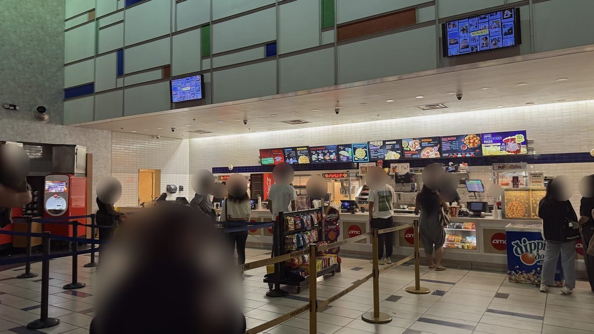 People lined up at the AMC concession stand before an evening movie
