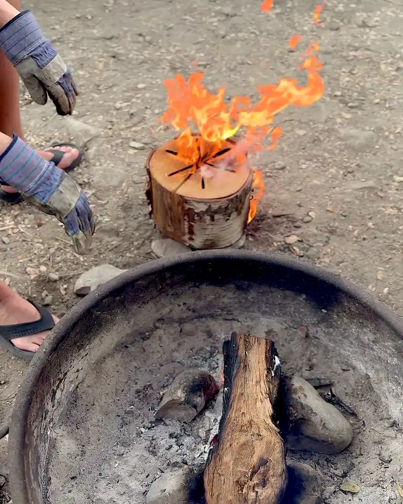 Cooking on a Fire Pit at Camp (6 Things We Made, From Lamb Chops to Pork Belly) A Swedish fire log burning from the top next to the fire ring at our campsite