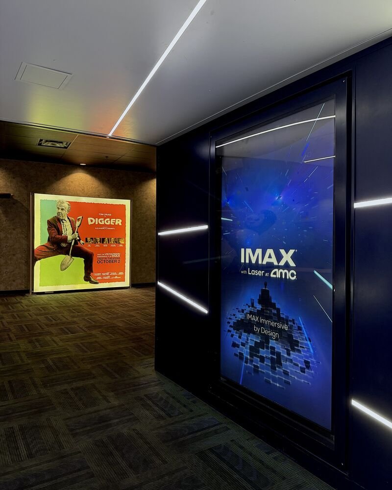 Digger lightbox poster at the end of a hallway next to a blue IMAX entrance panel