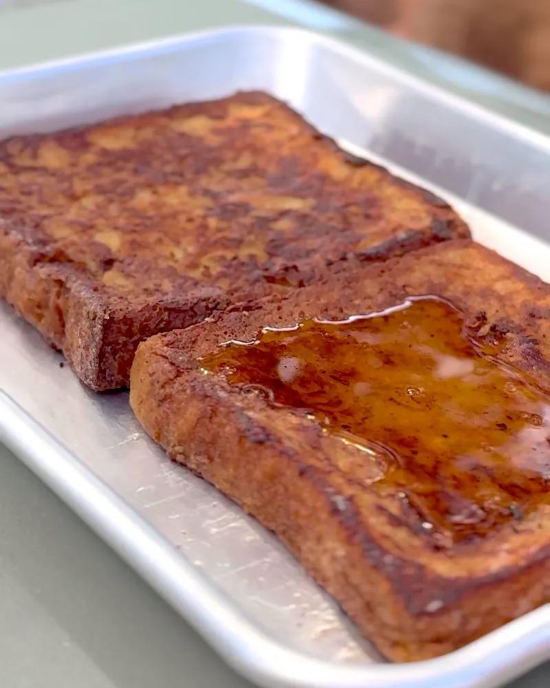 Easy Camping Breakfast: 4 Campfire Griddle Meals We Made (Nothing Prepped at Home) Campfire French toast with syrup on a metal camp tray