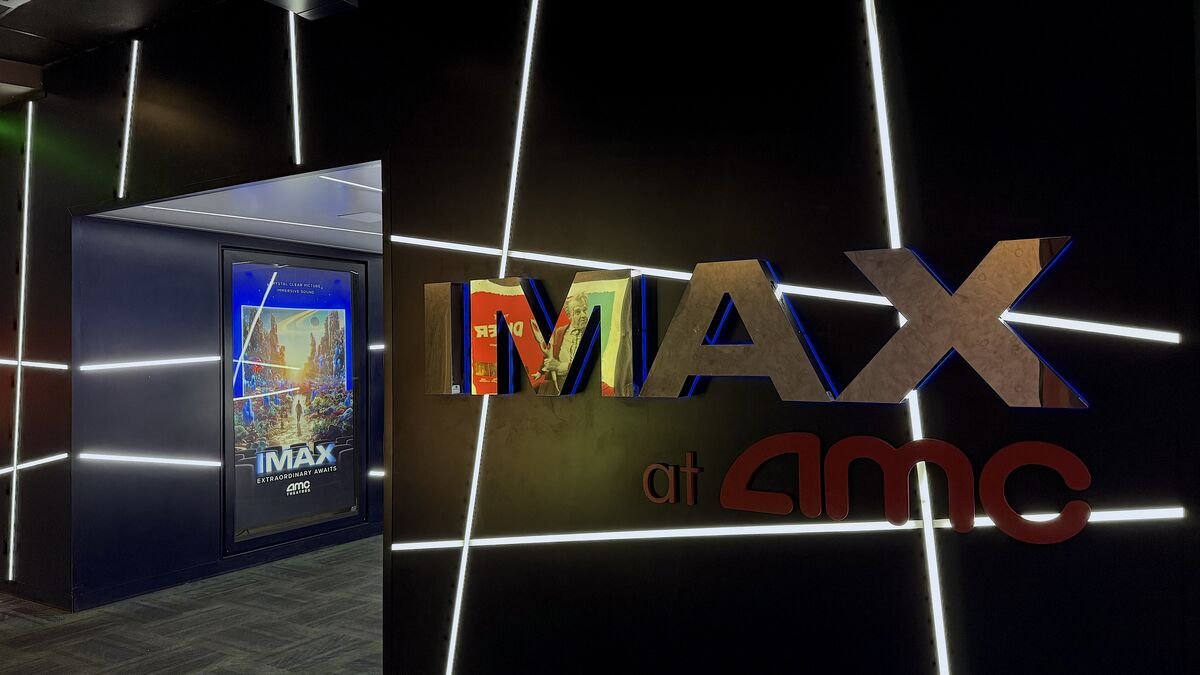 IMAX at AMC sign and auditorium entrance glowing with white light lines