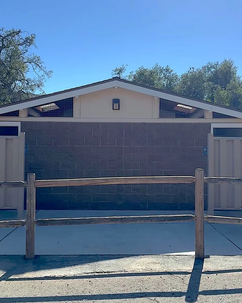 Steckel Park Camping With 3 Dogs: Our Honest Review of This Oak-Shaded Campground Restroom and shower building with a wooden fence in front