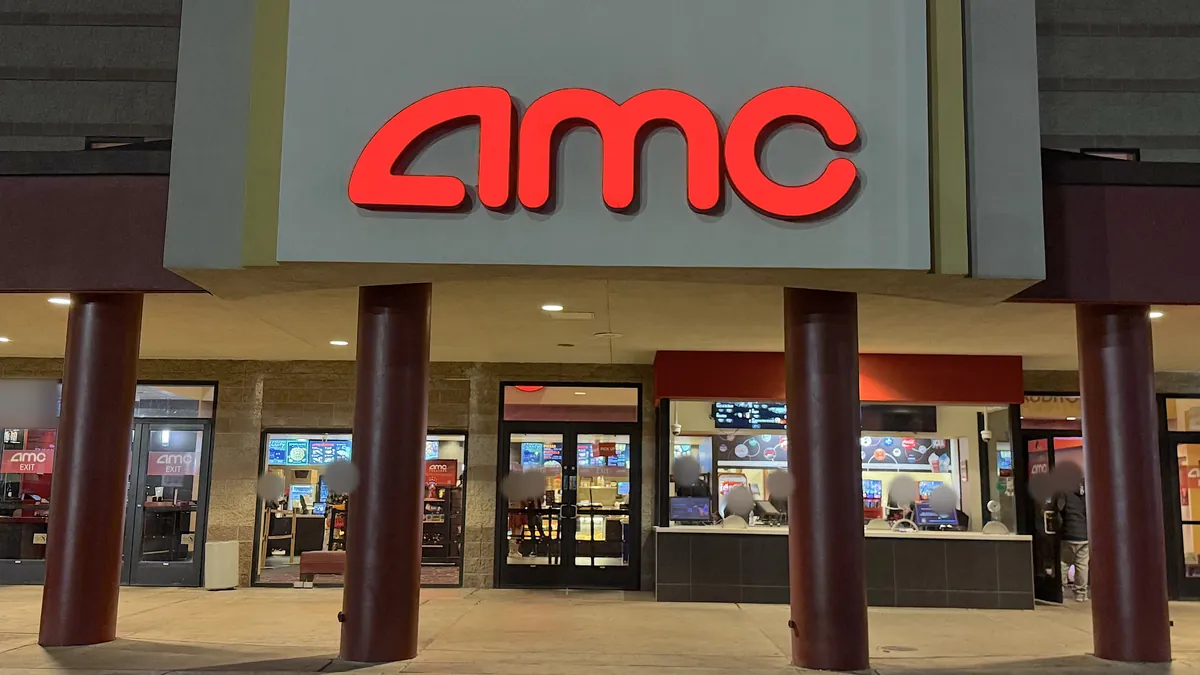 Is The Social Reckoning Worth Seeing? My 7.5/10 Review (No Spoilers) AMC movie theater entrance at night with the red sign above the glass doors and box office